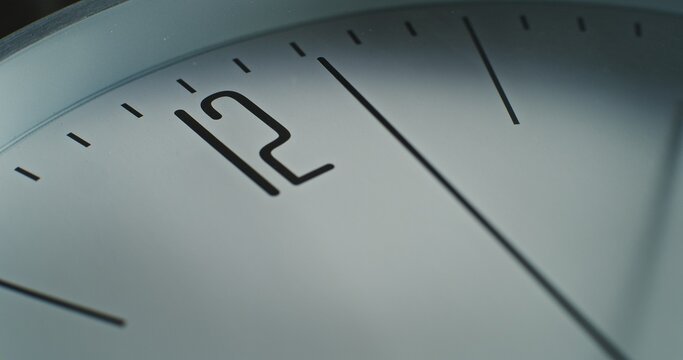 Time Lapse of Minimalist Wall Clock with Number 12 on the Dial and Running Second Hand. Modern Design Element of Interior. Concept of Time, Punctuality, Waiting and Time Management. Macro Close Up.