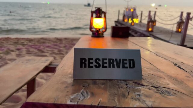 evening sea ocean lamp reserved table at a beachside cafe. Panorama of the city, ocean view, very nice decor, relaxing on the beach. Rich vacation