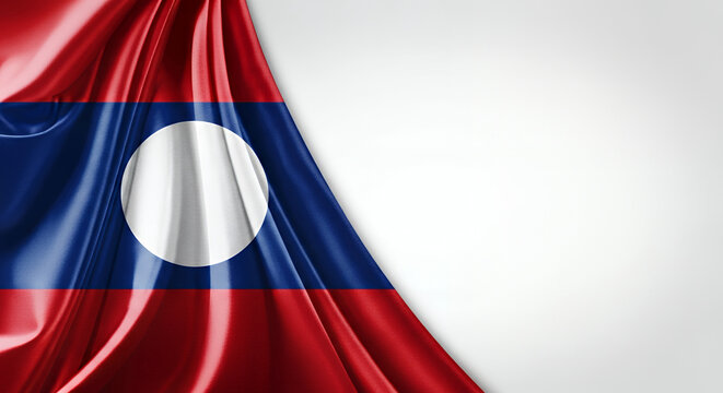 Laotian flag waves gently against a white backdrop, symbolizing national pride and cultural heritage with vibrant colors and smooth silk texture. - Powered by Adobe