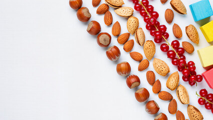 Colorful display of nuts and berries set on a white background