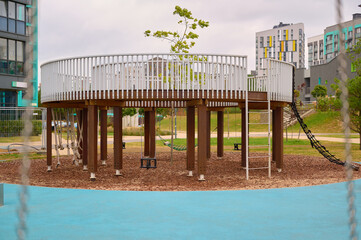 Modern playground climbing structure with seating area