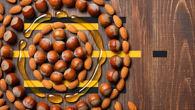 Creative arrangement of nuts and oil on wooden surface