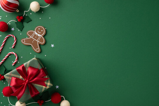 A festive Christmas scene features a wrapped gift, gingerbread man, candy canes, and red bows on a green backdrop, evoking holiday warmth, joy, and celebration for the season and new year