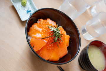 a delicious authentic sashimi rice bowl with masago or capelin roe on top and miso soup on the side