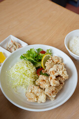 chicken karaage with fresh green salad and sliced cabbage