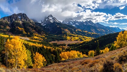 Autumnal mountain valley with vibrant fall colors and snow-capped peaks