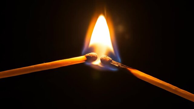 Igniting passion: Striking matchsticks with bright flame against dark background