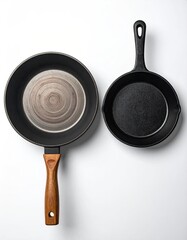 Two cast iron skillets, one large and one small, sit atop a white surface