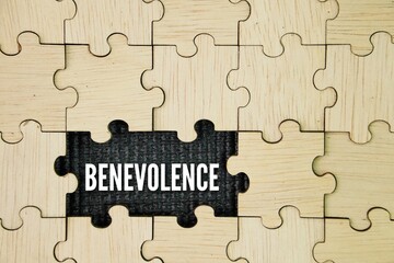 Wooden puzzle with the word benevolence. volunteer concept. desire to do good to others; goodwill; charitableness. to be filled with benevolence toward one's fellow creatures