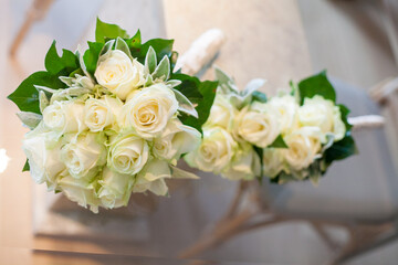 Beautiful white rose bouquets artfully arranged with greenery, perfect for weddings or special occasions