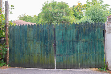 Fototapeta premium An old, green-blue wooden fence or gate. Rustic and natural texture.