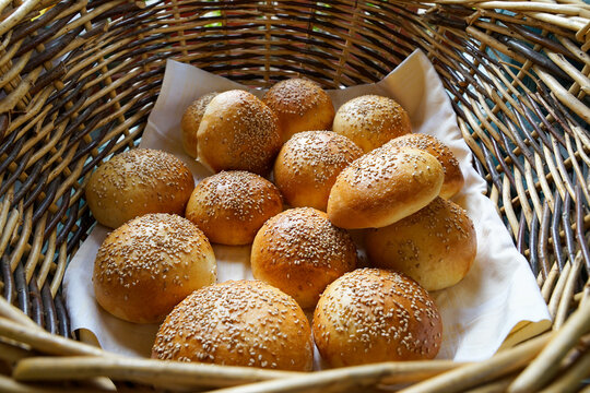 Freshly homemade buns with sesame seeds in natural basket