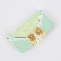 Green wallet with beautiful pattern isolated white background