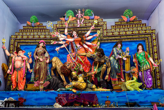 Vibrant Durga Puja Shrine With Goddess Durga And Attendants In Ornate Backdrop