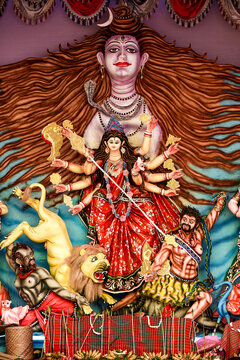 Vibrant Durga Puja Shrine With Goddess Durga And Attendants In Ornate Backdrop