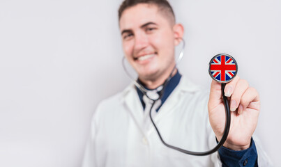 Doctor showing stethoscope with United Kingdom flag. United Kingdom national healthcare concept