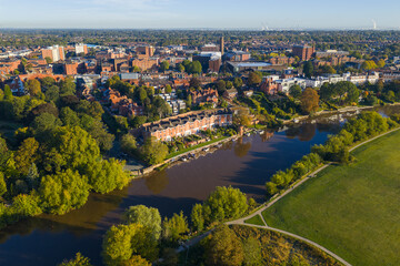Aerial image of Chester riverside homes and River Dee with morning reflections and greenery.