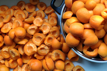 Fresh apricots are prepared and ground in a large pot to make traditional homemade apricot jam.