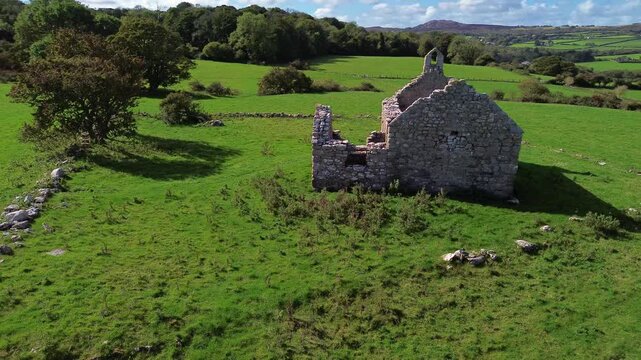 Lligwy chapel aerial view circling lush meadow farmland medieval churchyard ruins