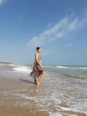 Young caucasian female posing confidently on a sandy beach