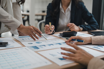 Businesswomen team discussing project, analyzing statistics, financial documents at corporate meeting