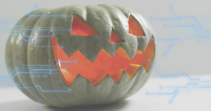 On start jack-o'-lantern glowing getting blue circuits fading pulsing around sides for tech theme