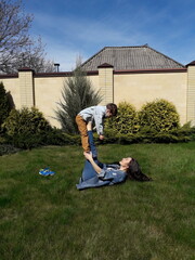 Young caucasian woman and boy playing outdoors in garden