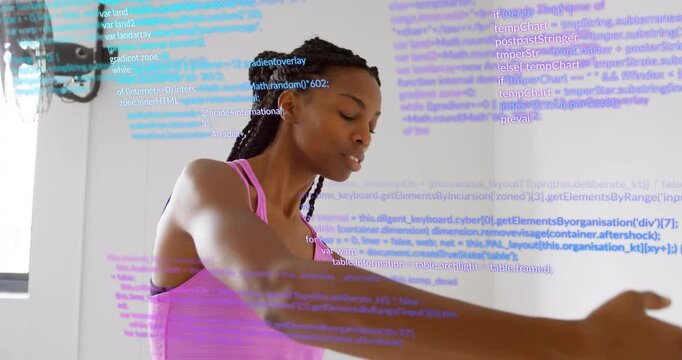 Upon entering, woman at barre performing ballet stretch under scrolling code overlay for technology