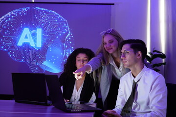multinational team of one man and two women gathered to brainstorm and discuss their work together. They used computers to present a stock market report using AI charts.