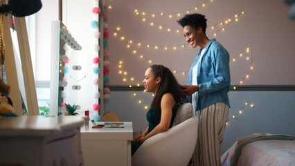 Mature Mother Helping Teenage Daughter In Bedroom At Home Getting Ready For Prom Or Night Out © Monkey Business