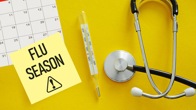 Flu Season ahead is shown as medical concept. The concept of seasonal diseases and treatment of colds, flu, heat. Prevention of virus. Mercury thermometer and stethoscope