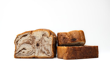 a loaf of bread with chocolate swirls inside, isolated on white background
