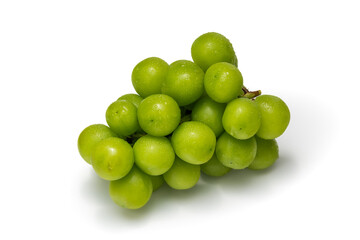 Close up of fresh green grapes with water drops on a white background