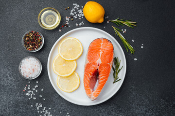Fresh salmon fillet prepared for cooking with lemon and herbs