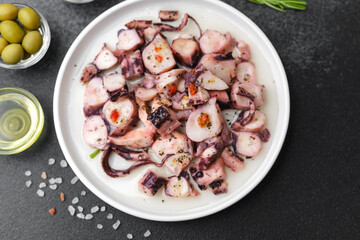 Octopus pieces in white bowl for salad preparation or healthy lunch concept