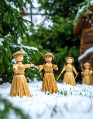Straw figures in snowy garden
