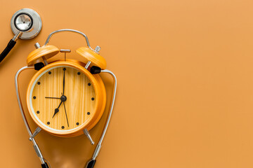 Stethoscope and vintage alarm clock, top view. Time for medical checkup