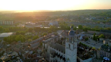 Halle, Vlaams Brabant, Belgium, 27th of April, 2025, A breathtakingly beautiful sunset is illuminating a historic town filled with stunning architecture and lush greenery