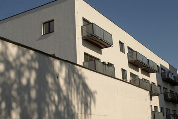Facade wall of a residential building with visible play of light and shadow. Urban housing architecture, reflecting everyday residential environment and visual contrasts in city landscapes.
