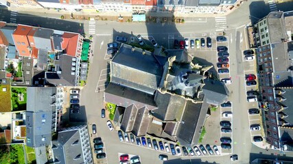 Enghien, Hainaut, Belgium, August 6th, 2024, Church of Saint Nicolas, An aerial shot beautifully showcasing a busy town square, surrounded by numerous cars and a historic structure