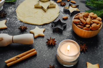 Cozy christmas baking with almonds and candle for warm holiday atmosphere and lifestyle concept