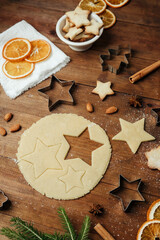 Christmas tree cookies with raw dough and wooden board for holiday food styling and festive background concept