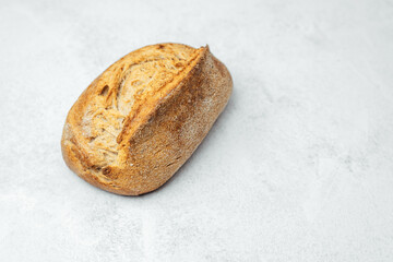 Freshly baked whole grain bread on textured surface ready to be served