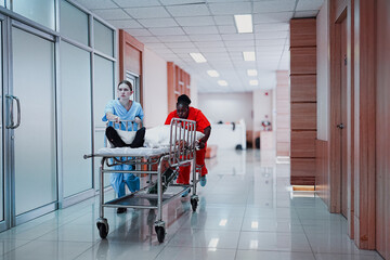 Team medical staff pushing stretcher gurney bed with injured patient to emergency room in hospital....