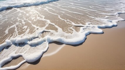Close-up of white sea foam on sandy beach shore with gentle waves and copy space. Perfect for travel, relaxation, nature, ocean backgrounds, wellness concepts, advertising, design projects, tourism