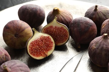 Whole and cut figs on table, closeup