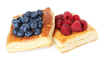 Yummy puff pastries with berries isolated on white
