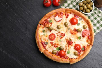 Delicious pizza with cheese, tomatoes and olives on black table, flat lay. Space for text