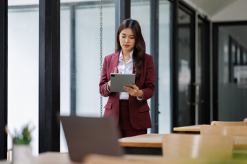 Obraz premium Tablet, business and asian woman in office online for social media, online report and planning. Happy, corporate worker and person on digital technology for project ideas, website and research 