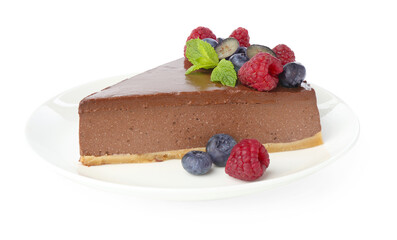 Piece of yummy chocolate cheesecake with berries isolated on white